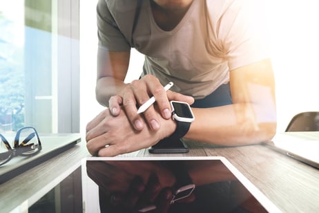 Website designer working with smart watch and digital tablet  and digital design diagram on wooden desk as concept